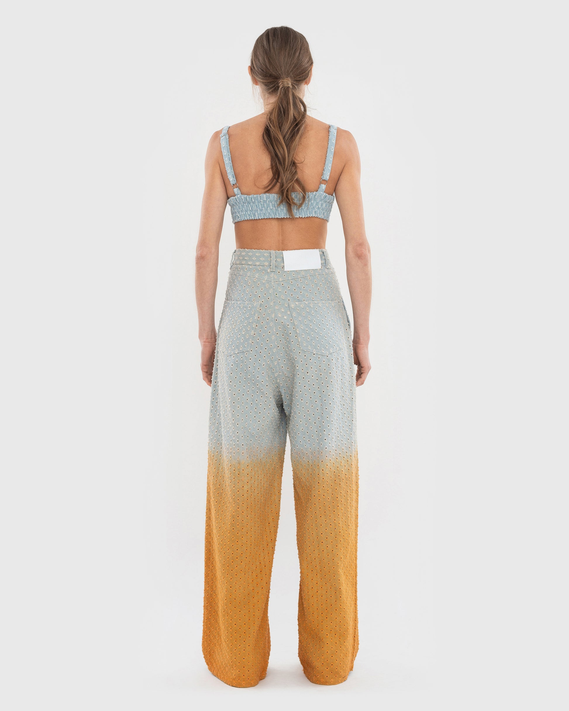 Buy Perforated Jeans with Orange Gradient – Bottoms by Ksenia Schnaider | Ethical & Sustainable Fashion